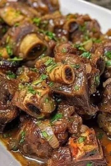 Queues de bœuf braisées savoureuses avec une sauce aux herbes